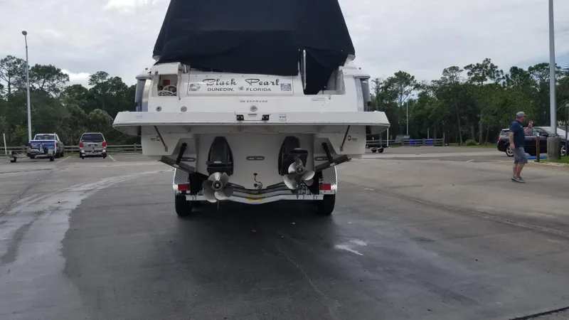 Slide: The Image of 2013 Regal 35 Express Cruiser boat on trailer, rear view, parked outdoors. - 10