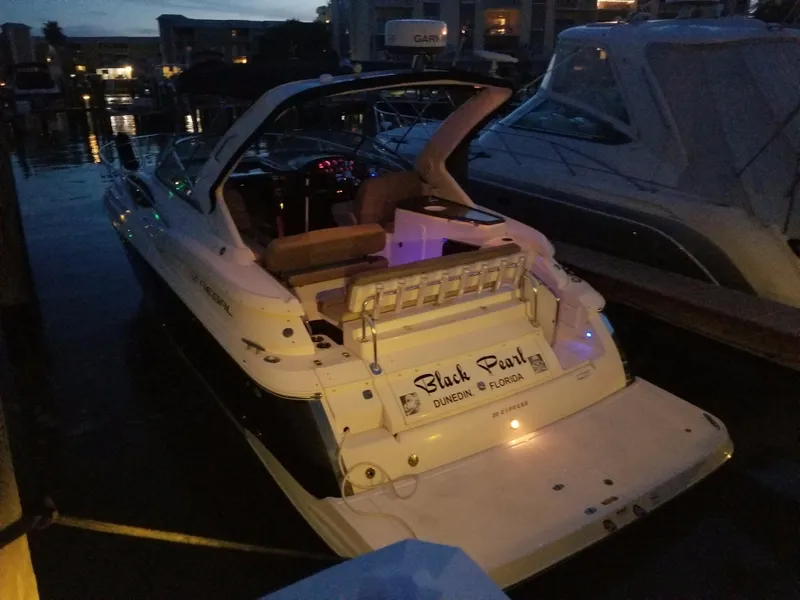 Slide: The Image of 2013 Regal 35 Express Cruiser docked at night with illuminated interior. - 11
