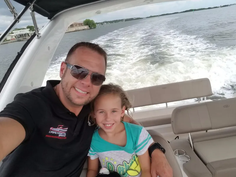 Slide: The Image of Father and daughter enjoying a ride on a 2013 Regal 35 Express Cruiser. - 12
