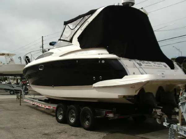 Slide: The Image of 2013 Regal 35 Express Cruiser on a trailer, black and white exterior. - 13