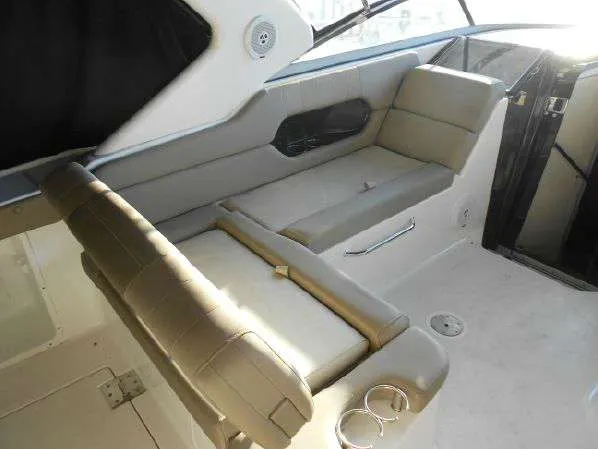 Slide: The Image of 2013 Regal 35 Express Cruiser interior seating area with beige upholstery. - 18