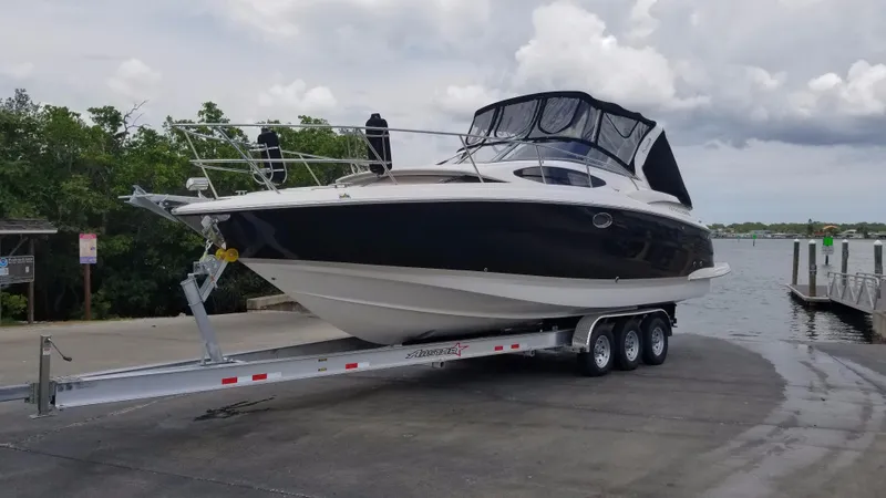 Slide: The Image of 2013 Regal 35 Express Cruiser on a trailer at a boat launch. - 2