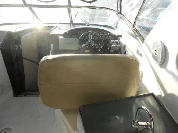 Slide: The Image of 2013 Regal 35 Express Cruiser helm with beige seat and steering wheel. - 23