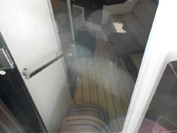 Slide: The Image of 2013 Regal 35 Express Cruiser interior with wooden flooring and seating area. - 27