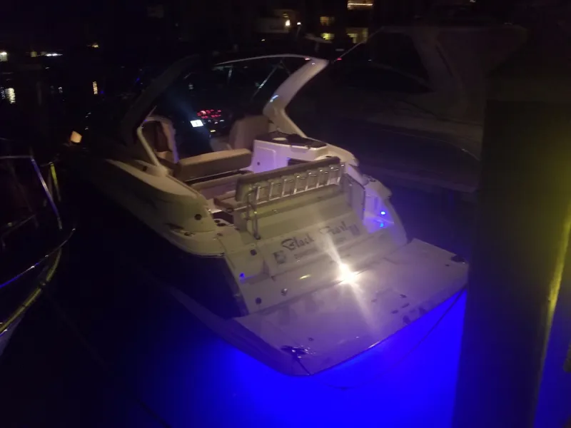 Slide: The Image of 2013 Regal 35 Express Cruiser illuminated at night in a marina. - 3