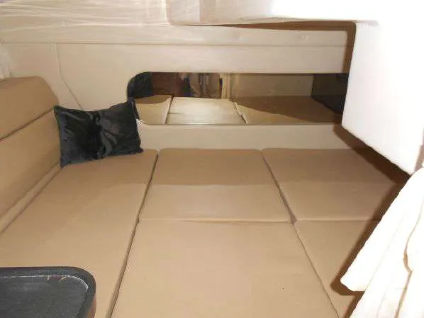 Slide: The Image of Interior cabin of 2013 Regal 35 Express Cruiser with beige seating and black pillow. - 30
