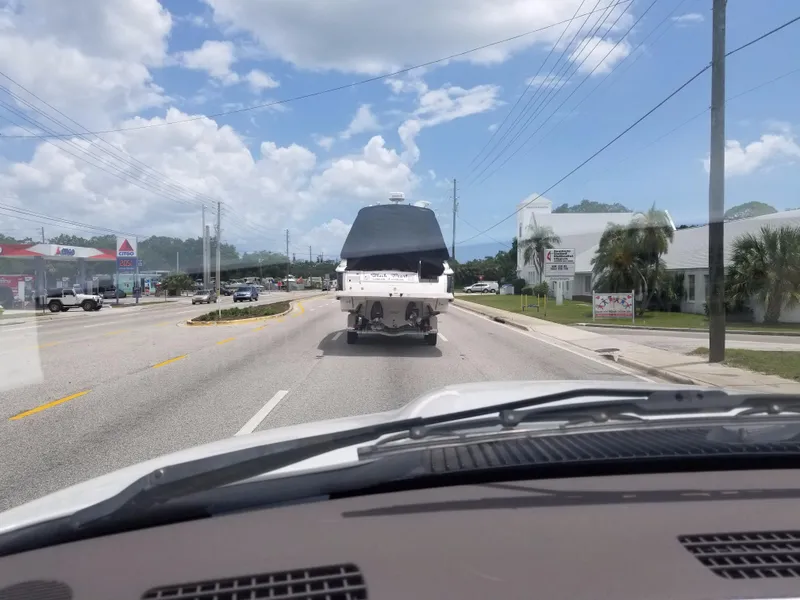Slide: The Image of 2013 Regal 35 Express Cruiser being towed on a sunny day. - 31