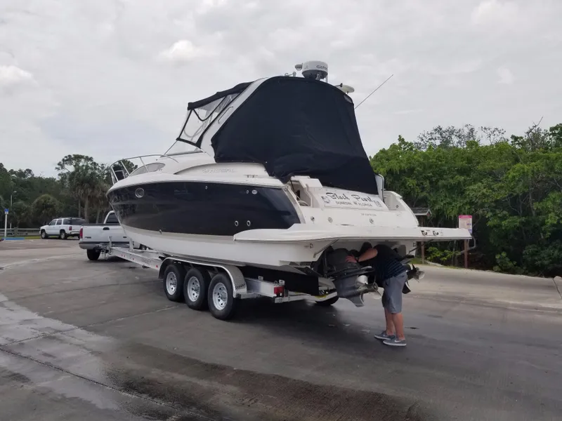 Slide: The Image of 2013 Regal 35 Express Cruiser on a trailer, being inspected at a boat ramp. - 32