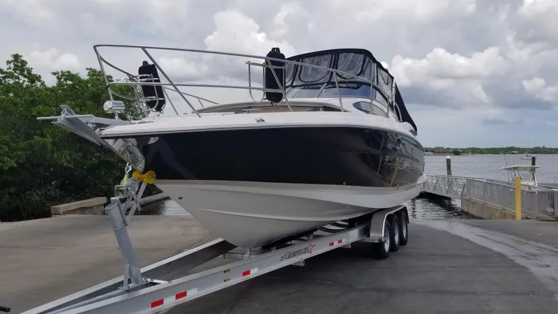 Slide: The Image of 2013 Regal 35 Express Cruiser on a trailer at a boat launch. - 33