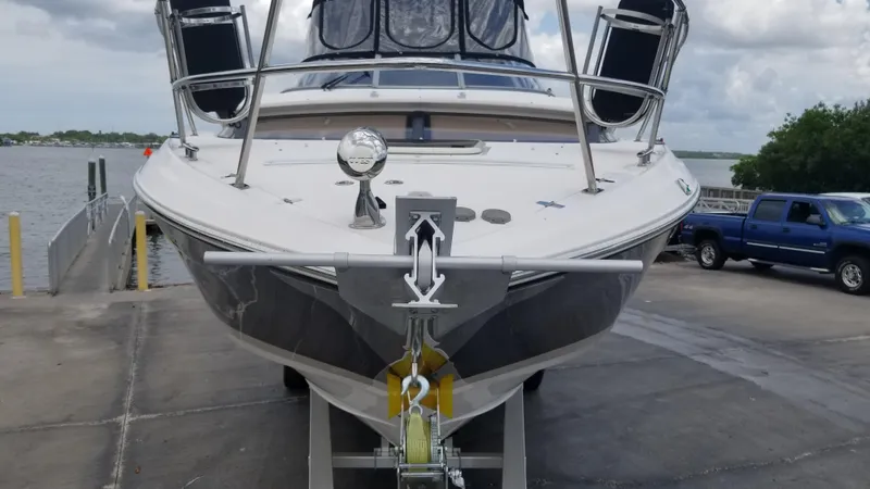 Slide: The Image of 2013 Regal 35 Express Cruiser on a boat ramp near a lake. - 34