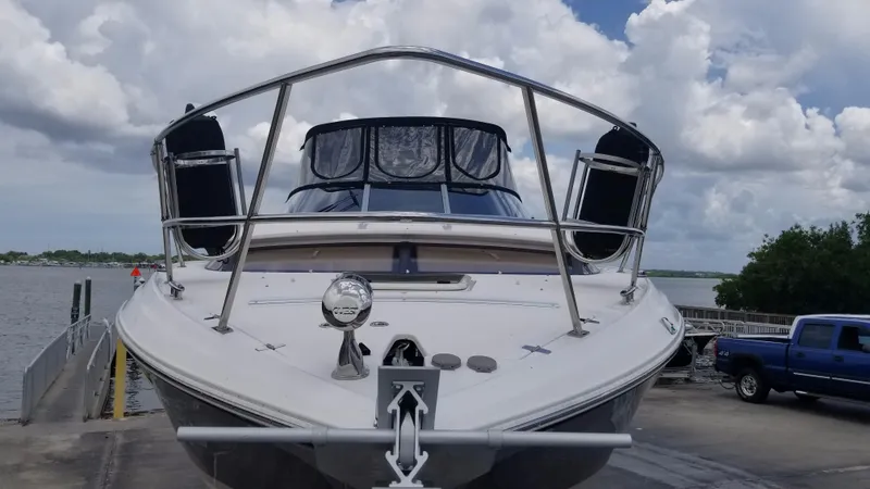 Slide: The Image of 2013 Regal 35 Express Cruiser docked at a marina with cloudy sky background. - 35