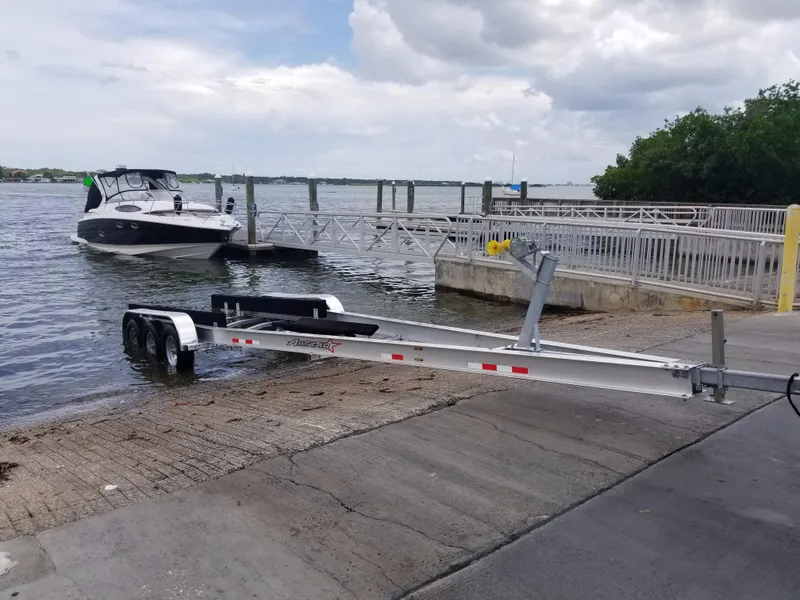 Slide: The Image of 2013 Regal 35 Express Cruiser at boat launch with trailer. - 40