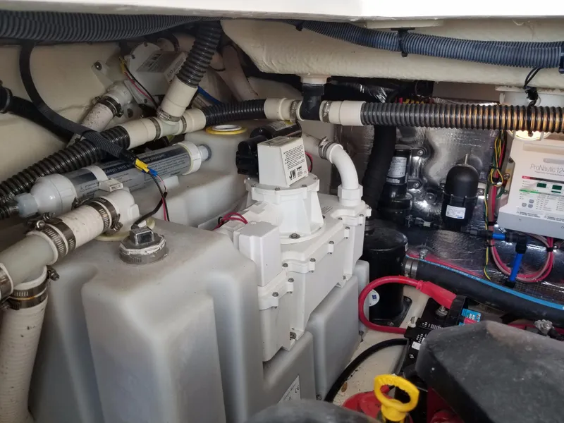 Slide: The Image of Engine compartment of a 2013 Regal 35 Express Cruiser with various mechanical components. - 46