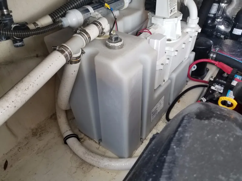 Slide: The Image of 2013 Regal 35 Express Cruiser engine compartment with water tank and hoses. - 48