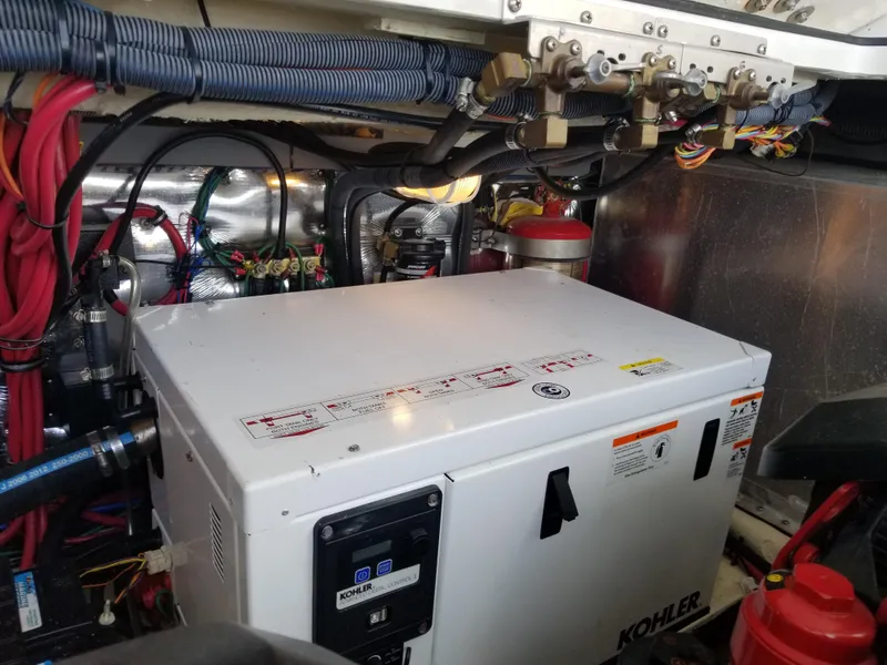 Slide: The Image of Engine compartment of a 2013 Regal 35 Express Cruiser with Kohler generator. - 49