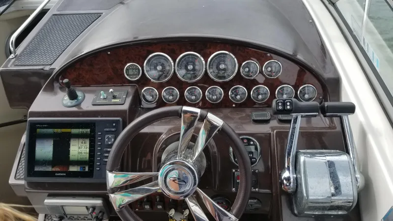Slide: The Image of Control panel of a 2013 Regal 35 Express Cruiser boat with gauges and navigation system. - 5