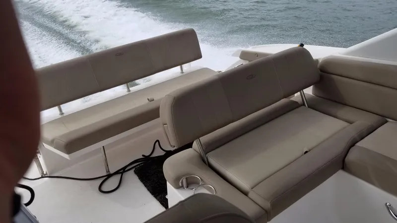 Slide: The Image of 2013 Regal 35 Express Cruiser boat interior with beige seating. - 9