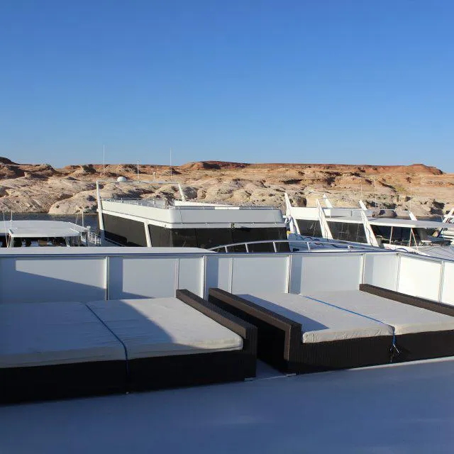 Slide: The Image of Bravada Houseboat Apollo Trip #7, 2013 model, docked with sunbeds on deck. - 10