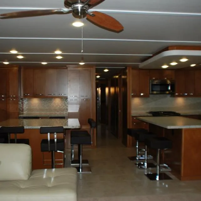 Slide: The Image of Modern kitchen interior of 2013 Bravada Houseboat Apollo Trip #7 with wooden cabinets and bar stools. - 17