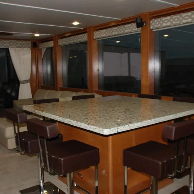 Slide: The Image of Luxurious interior of 2013 Bravada Houseboat Apollo Trip #7 with granite countertop and bar stools. - 19