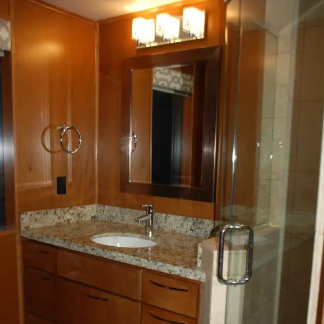 Slide: The Image of 2013 Bravada Houseboat Apollo Trip #7 bathroom with granite countertop and glass shower. - 22