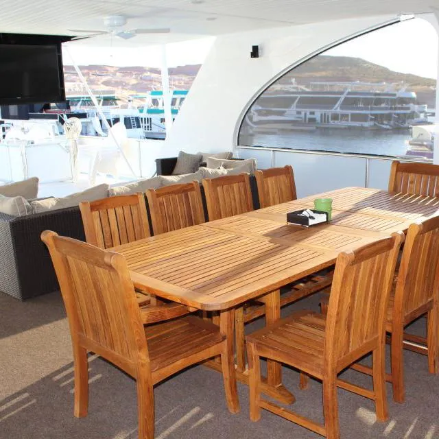 Slide: The Image of Spacious dining area on 2013 Bravada Houseboat Apollo Trip #7 with wooden table and chairs. - 25