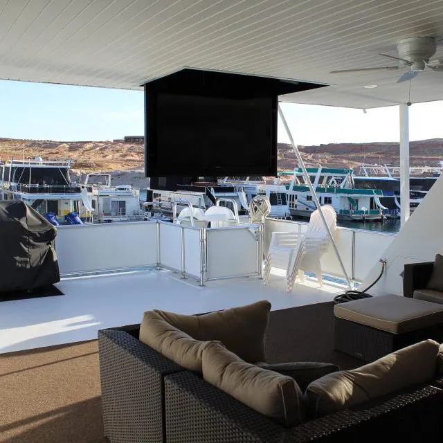 Slide: The Image of Upper deck of 2013 Bravada Houseboat Apollo Trip #7 with TV, seating, and marina view. - 4