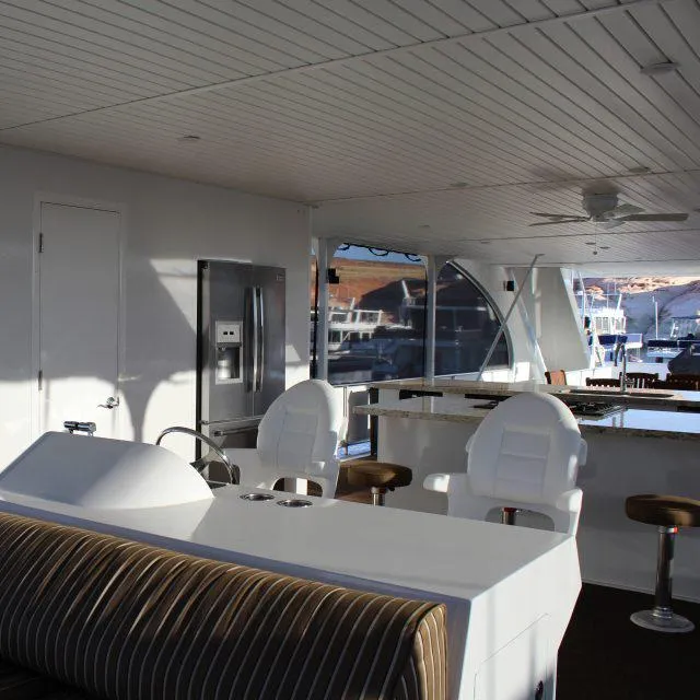 Slide: The Image of Interior of 2013 Bravada Houseboat Apollo Trip #7 with modern seating and kitchen area. - 7