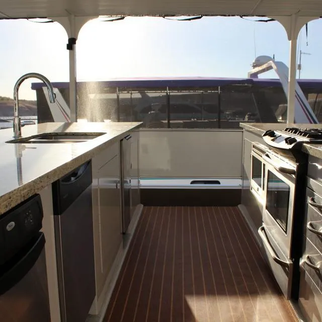 Slide: The Image of Modern kitchen on 2013 Bravada Houseboat Apollo Trip #7 with granite countertops and stainless steel appliances. - 8