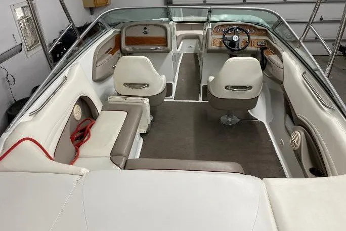 Slide: The Image of Interior of a 2000 Cobalt 246 boat with white and beige seating. - 11
