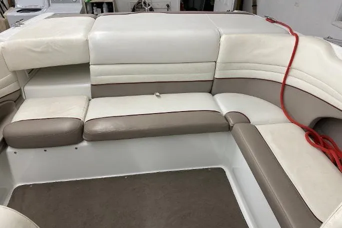 Slide: The Image of Interior seating of a 2000 Cobalt 246 boat with white and beige upholstery. - 12