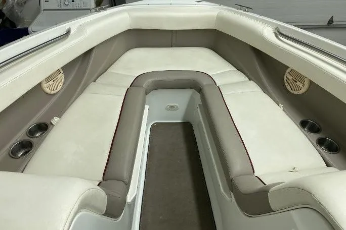 Slide: The Image of Interior of a 2000 Cobalt 246 boat with cushioned seating and cup holders. - 7