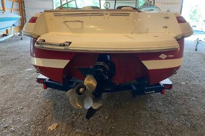 Slide: The Image of Rear view of a 2000 Cobalt 246 boat in a storage area. - 3