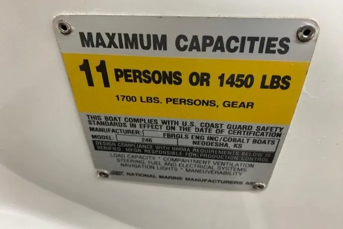 Slide: The Image of Plaque showing maximum capacity for Cobalt 246 boat: 11 persons or 1450 lbs, 1700 lbs with gear. - 19