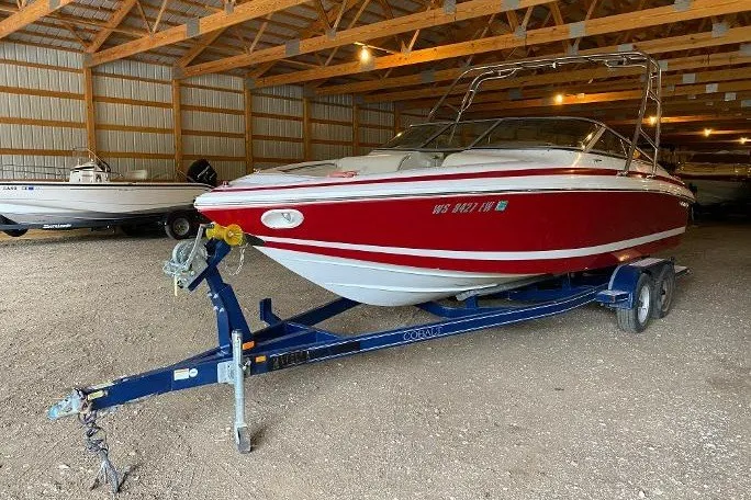 Slide: The Image of Red 2000 Cobalt 246 boat on trailer in a storage facility. - 1