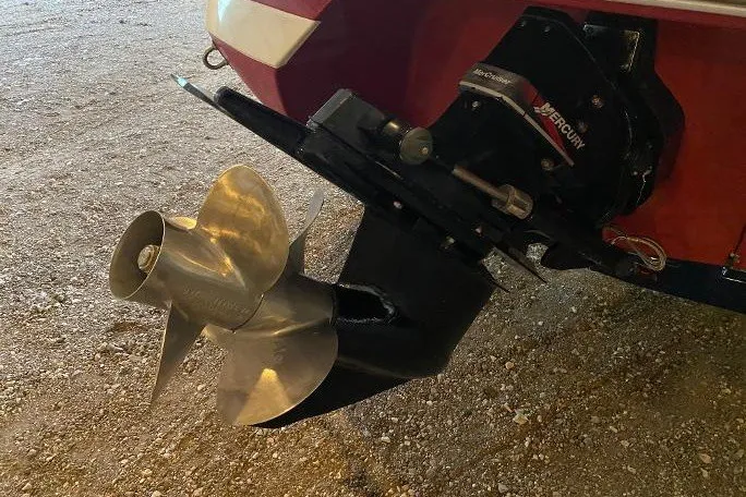Slide: The Image of Propeller and outdrive of a 2000 Cobalt 246 boat on gravel surface. - 4