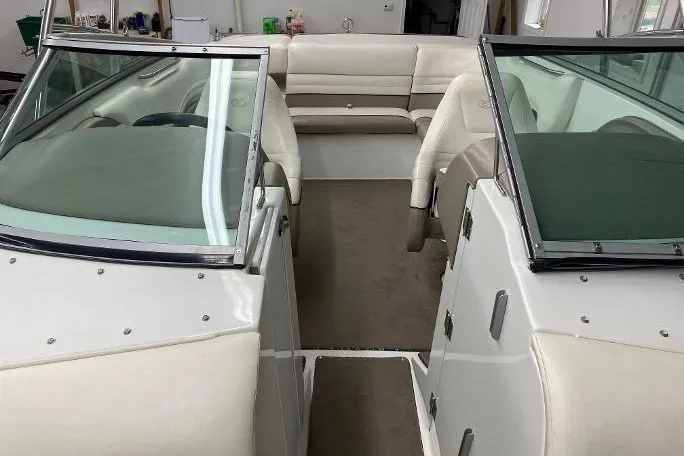 Slide: The Image of Interior view of a 2000 Cobalt 246 boat with white seating and dual windshields. - 13