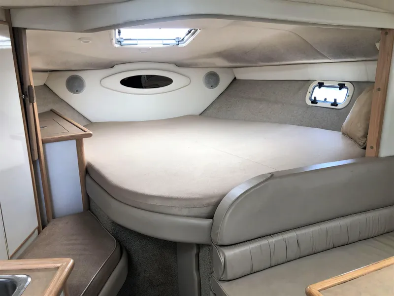 Slide: The Image of Interior cabin of 1997 Maxum 3200 SCR boat, featuring a cozy sleeping area. - 12