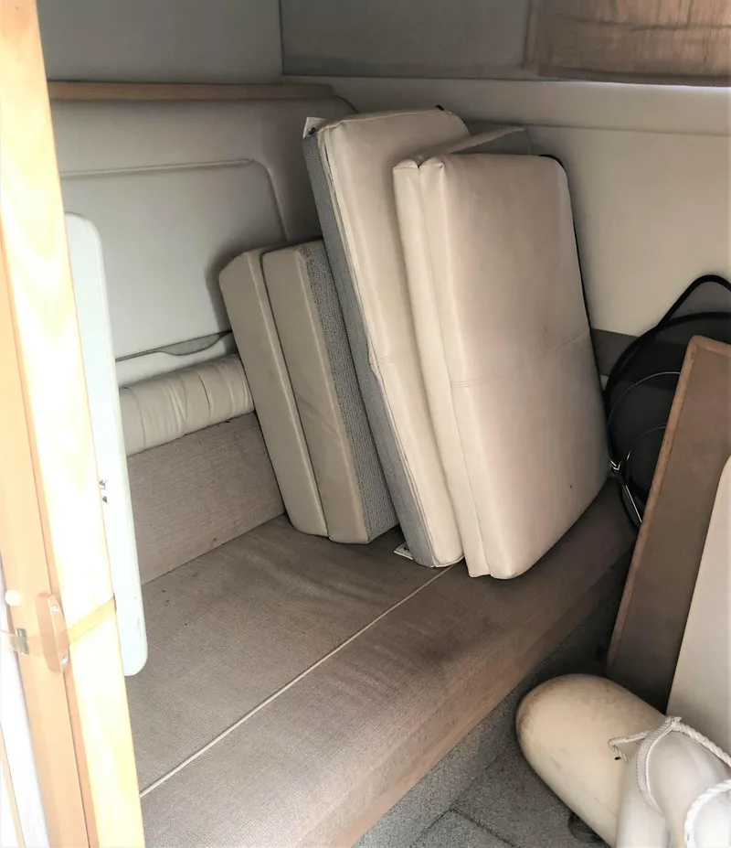 Slide: The Image of Interior cabin of 1997 Maxum 3200 SCR boat with beige cushions. - 14