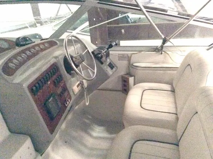 Slide: The Image of 1997 Maxum 3200 SCR boat interior with steering wheel and dashboard controls. - 15