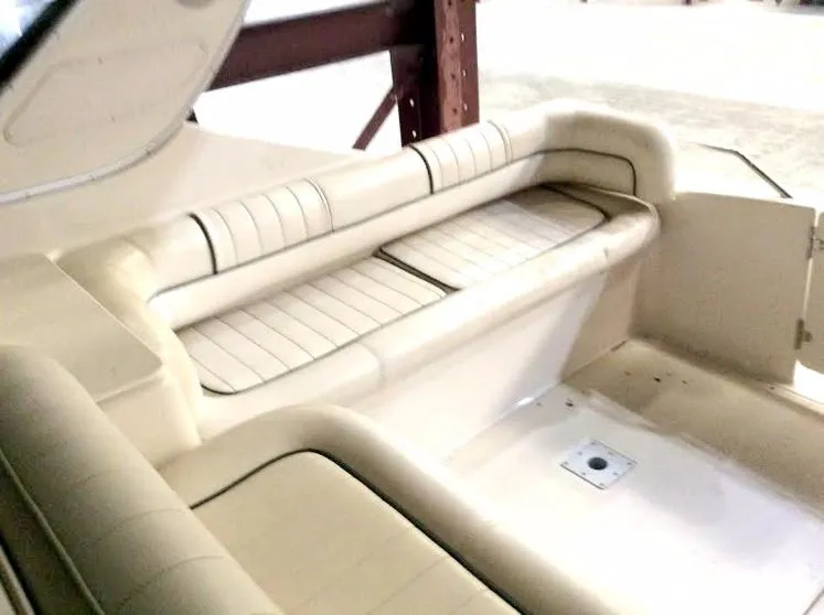 Slide: The Image of 1997 Maxum 3200 SCR boat interior with beige seating and storage compartments. - 17