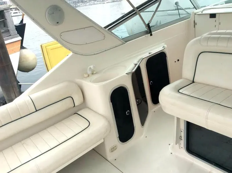 Slide: The Image of 1997 Maxum 3200 SCR boat interior with white seating and storage compartments. - 18