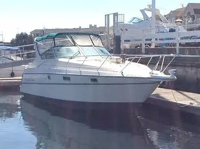 Slide: The Image of 1997 Maxum 3200 SCR boat docked at marina, featuring sleek design and spacious cabin. - 4