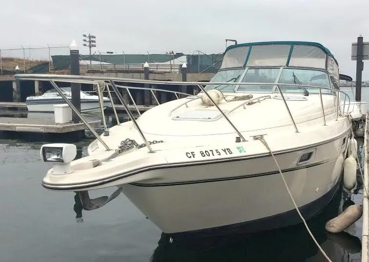 Slide: The Image of 1997 Maxum 3200 SCR boat docked at marina, featuring sleek design and spacious deck. - 5