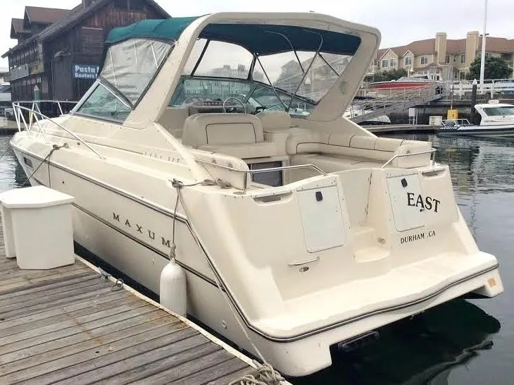 Slide: The Image of 1997 Maxum 3200 SCR boat docked at marina, rear view with canopy. - 6