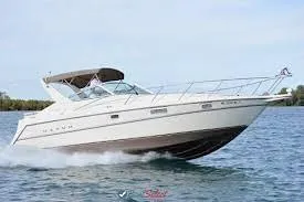 Slide: The Image of 1997 Maxum 3200 SCR cruising on open water, showcasing sleek design and performance. - 7