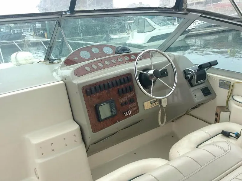 Slide: The Image of 1997 Maxum 3200 SCR boat cockpit with steering wheel and control panel. - 8