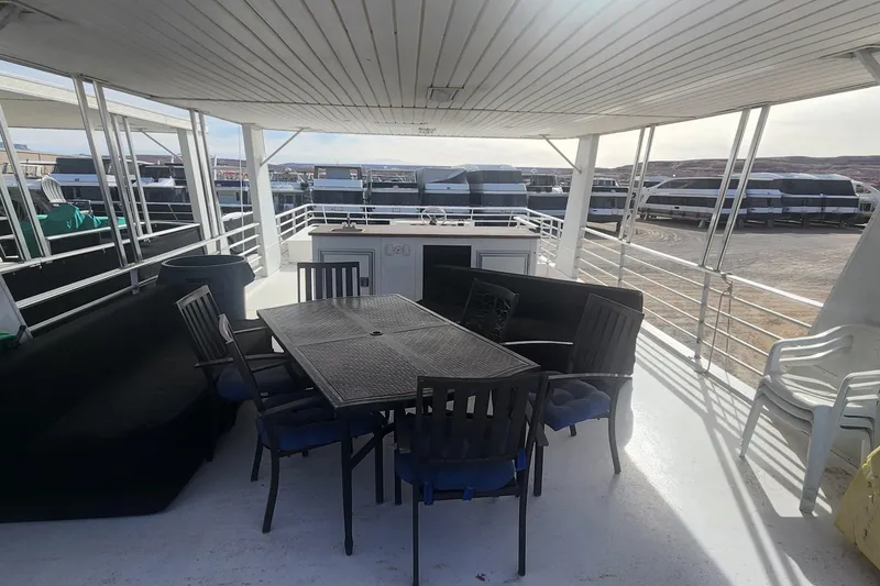 Slide: The Image of Upper deck of 2010 Destination Yachts Starchaser, featuring outdoor seating and dining area. - 13