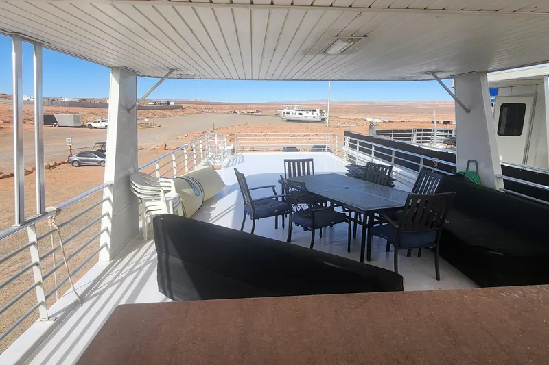 Slide: The Image of Upper deck of 2010 Destination Yachts Starchaser, featuring outdoor seating and scenic views. - 14