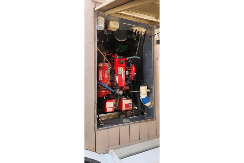 Slide: The Image of Engine compartment of 2010 Destination Yachts Starchaser Share #10, featuring red machinery components. - 4